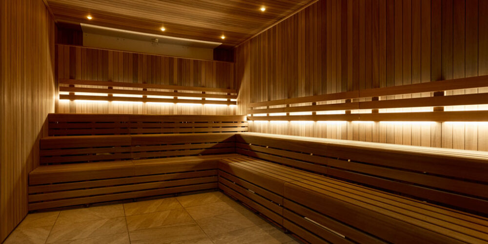 Wooden sauna benches with atmospheric lighting.
