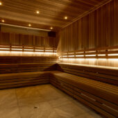 Wooden sauna benches with atmospheric lighting.