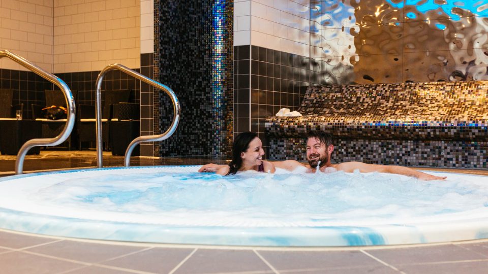 Couple relaxing in spa pool