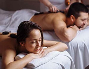 Couple enjoying hot stone massage