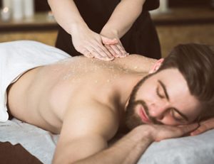 Man receiving back massage treatment