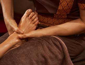 Relaxing Thai foot massage being performed
