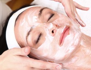 Lady relaxing with facial treatment