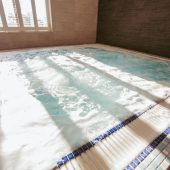 Moulton's spa pool, warm water bubbling with light shining through slatted blinds.