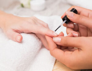 Lady receiving manicure treatment